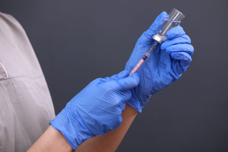 Medical hand gloves dispose medication drug needle syringe drug,concept flu shot vaccine vial dose hypodermic injection treatment disease in hospital,prevention immunization children.